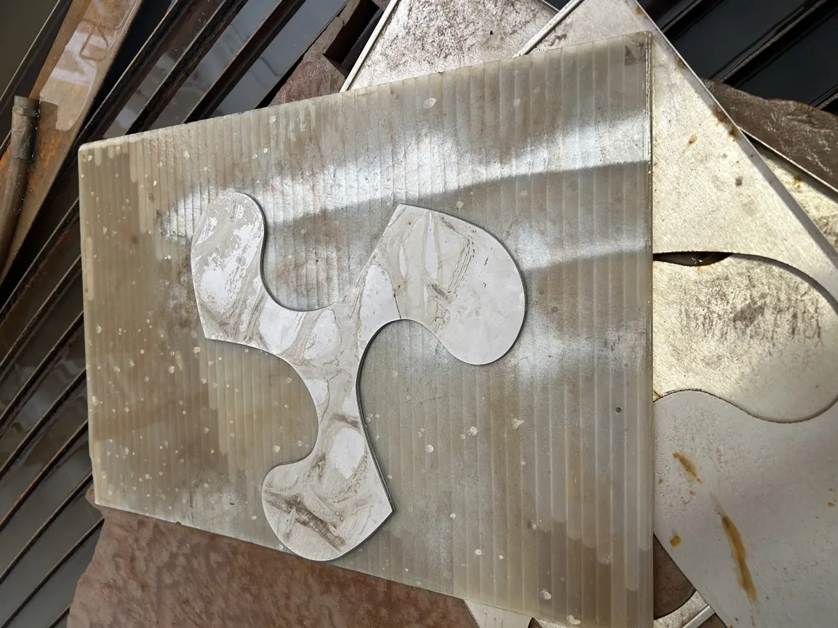 Organic shape cut in marble tile